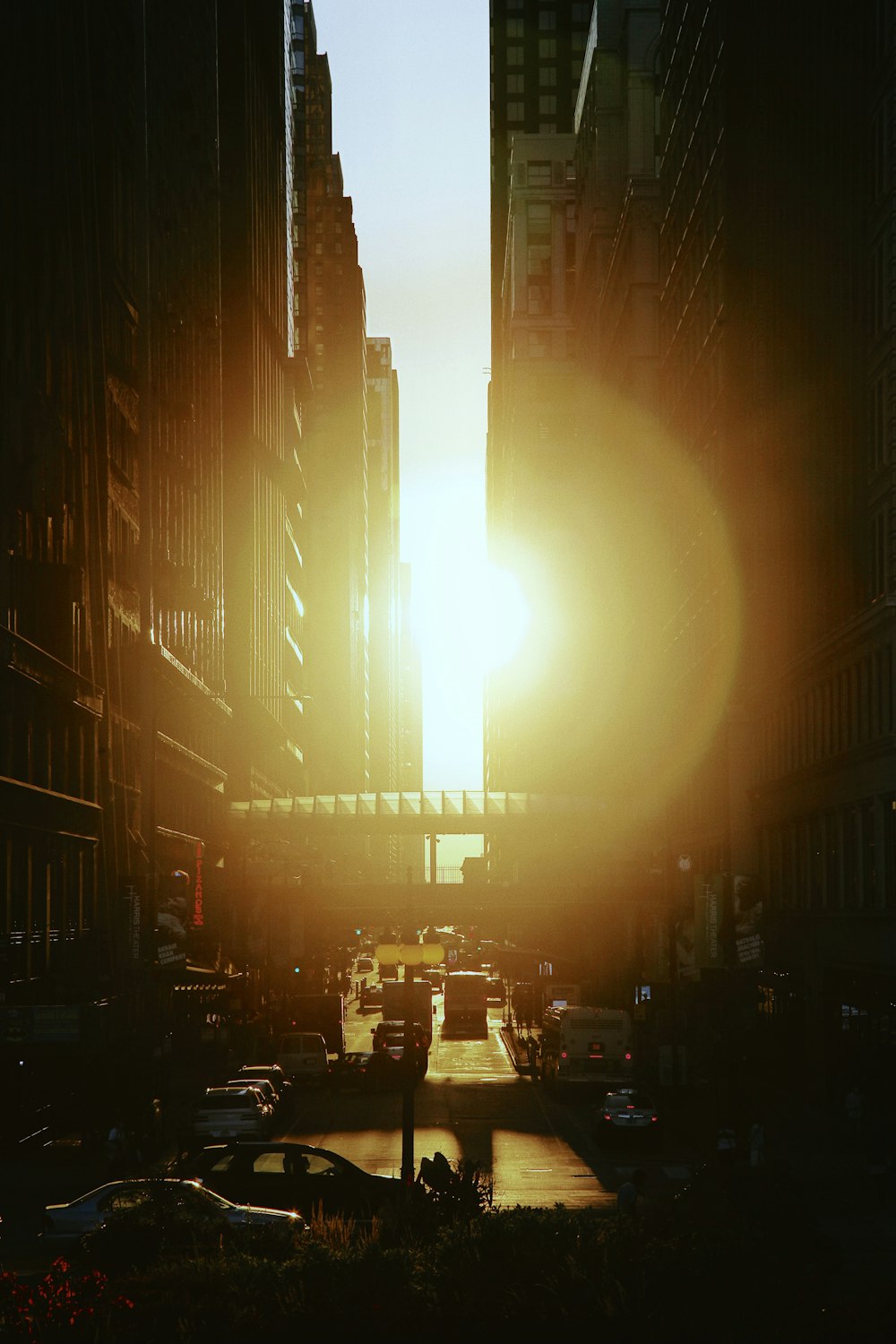 the sun is setting over a busy city street