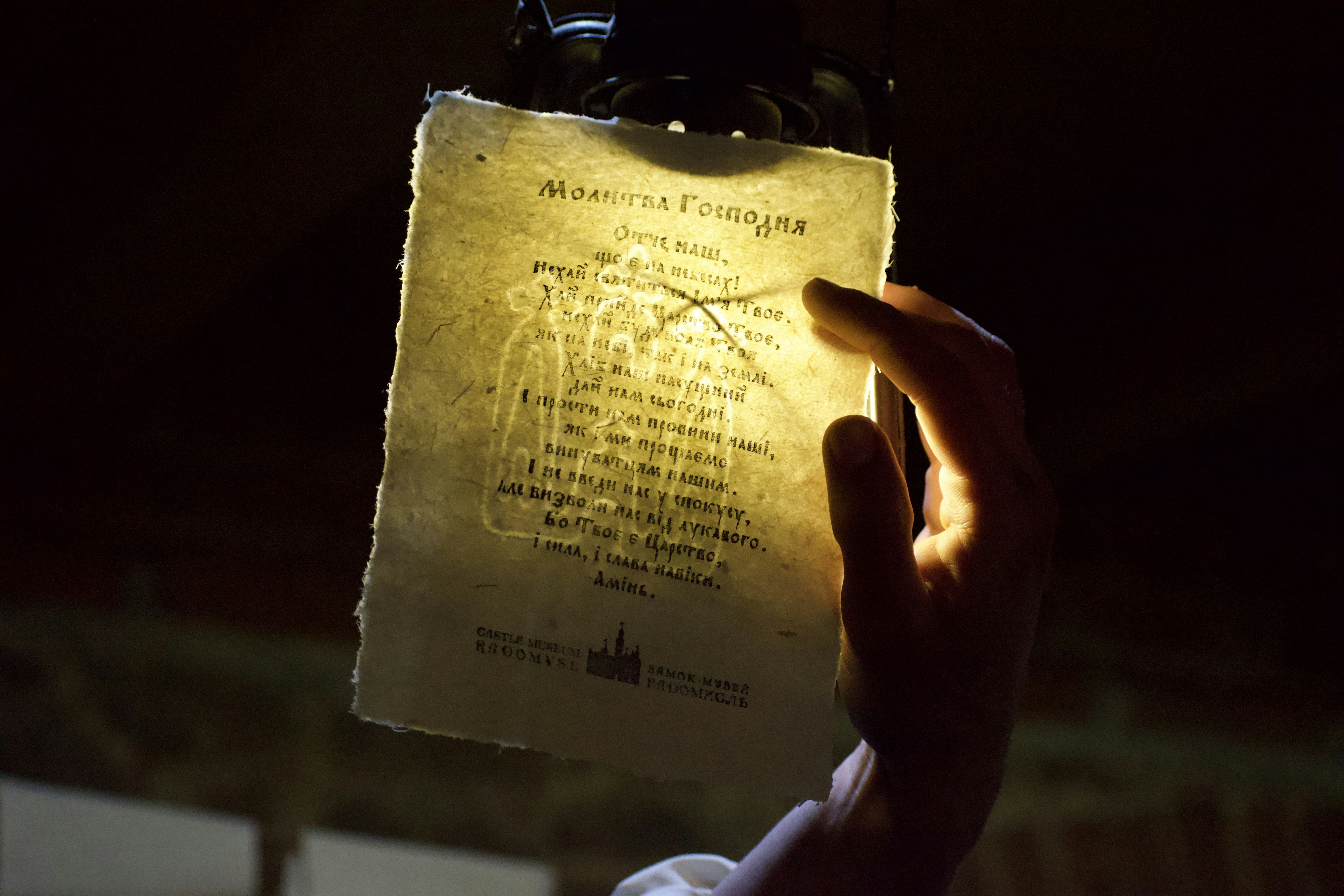 a person holding up a piece of paper with writing on it