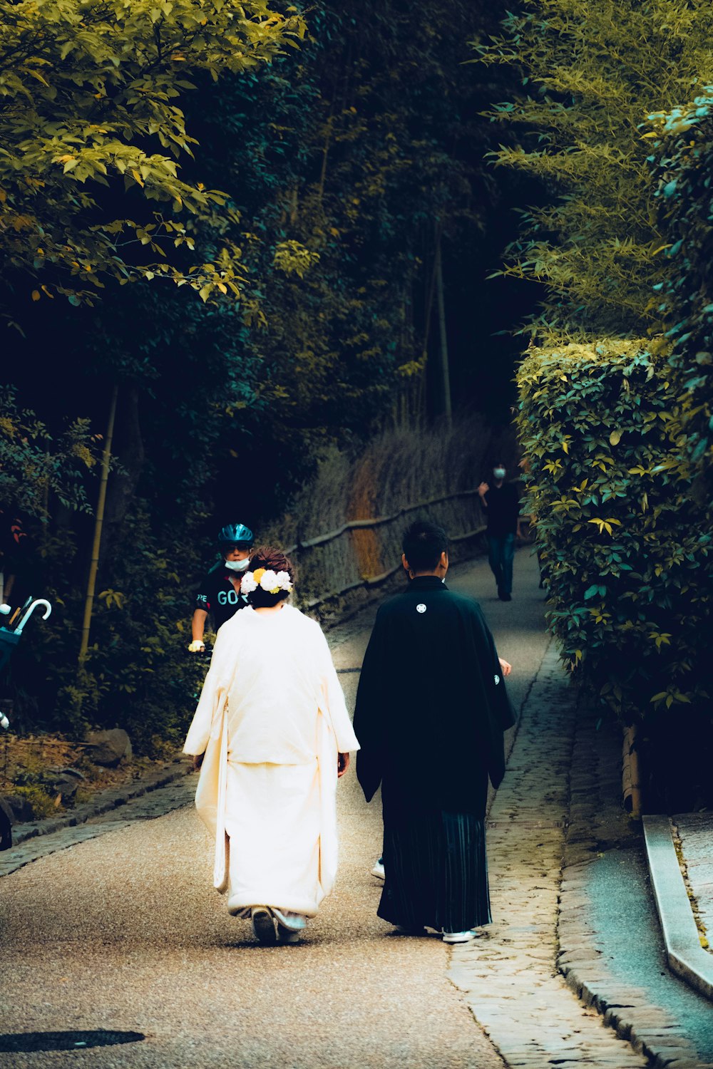 a priest and a nun walking down a path