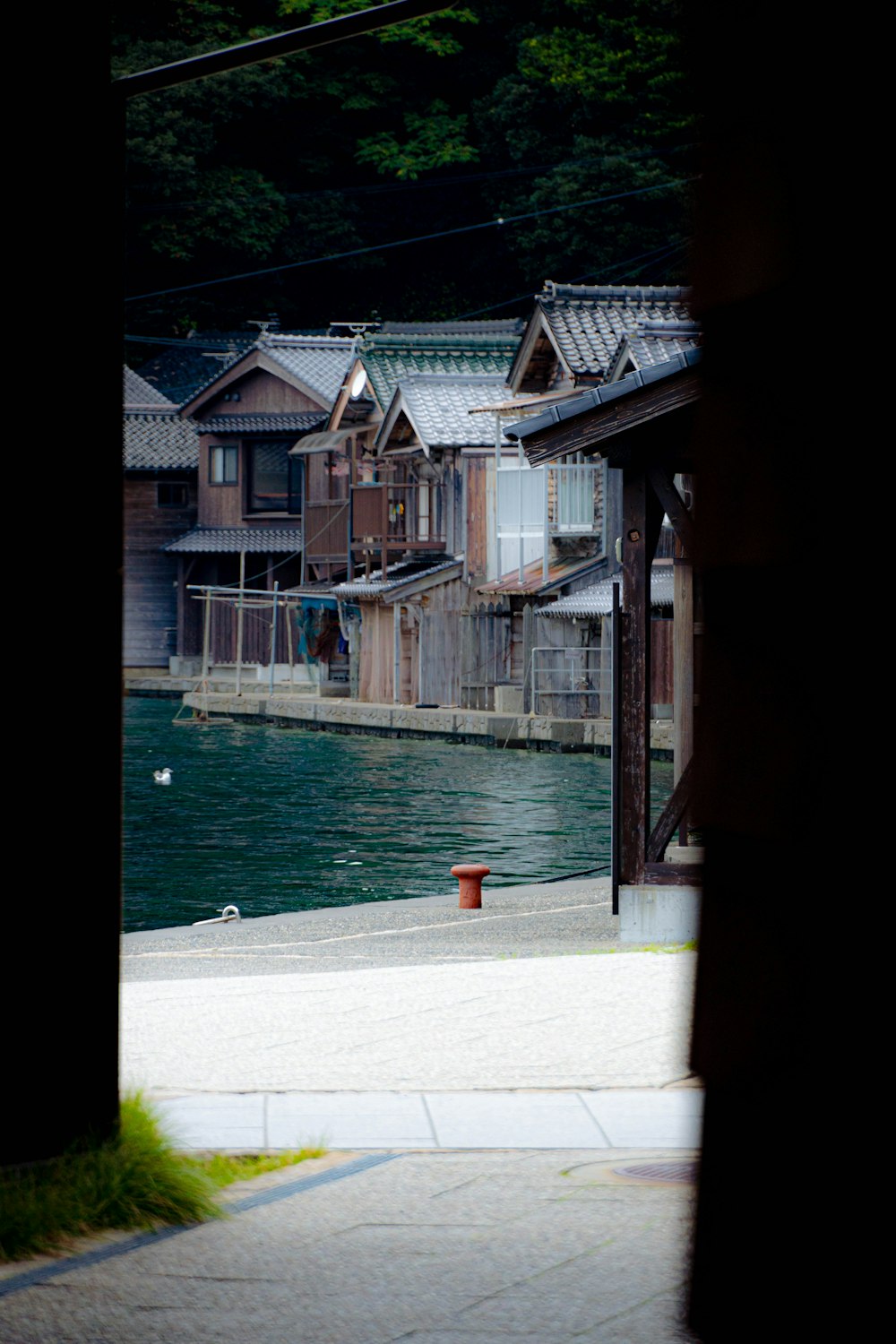 a view of a body of water with houses in the background