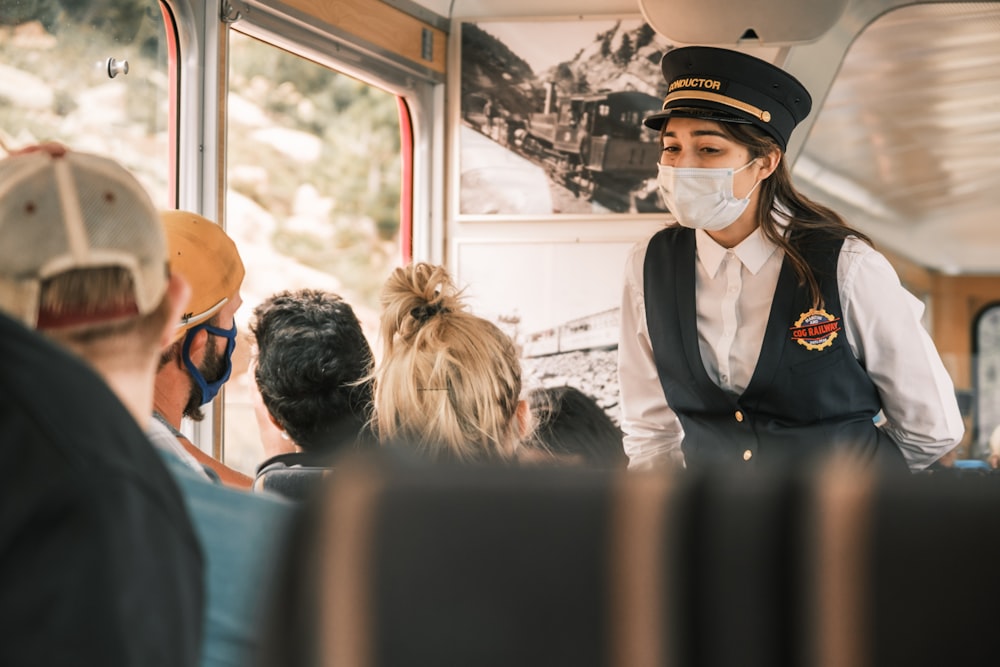 a woman wearing a face mask on a bus