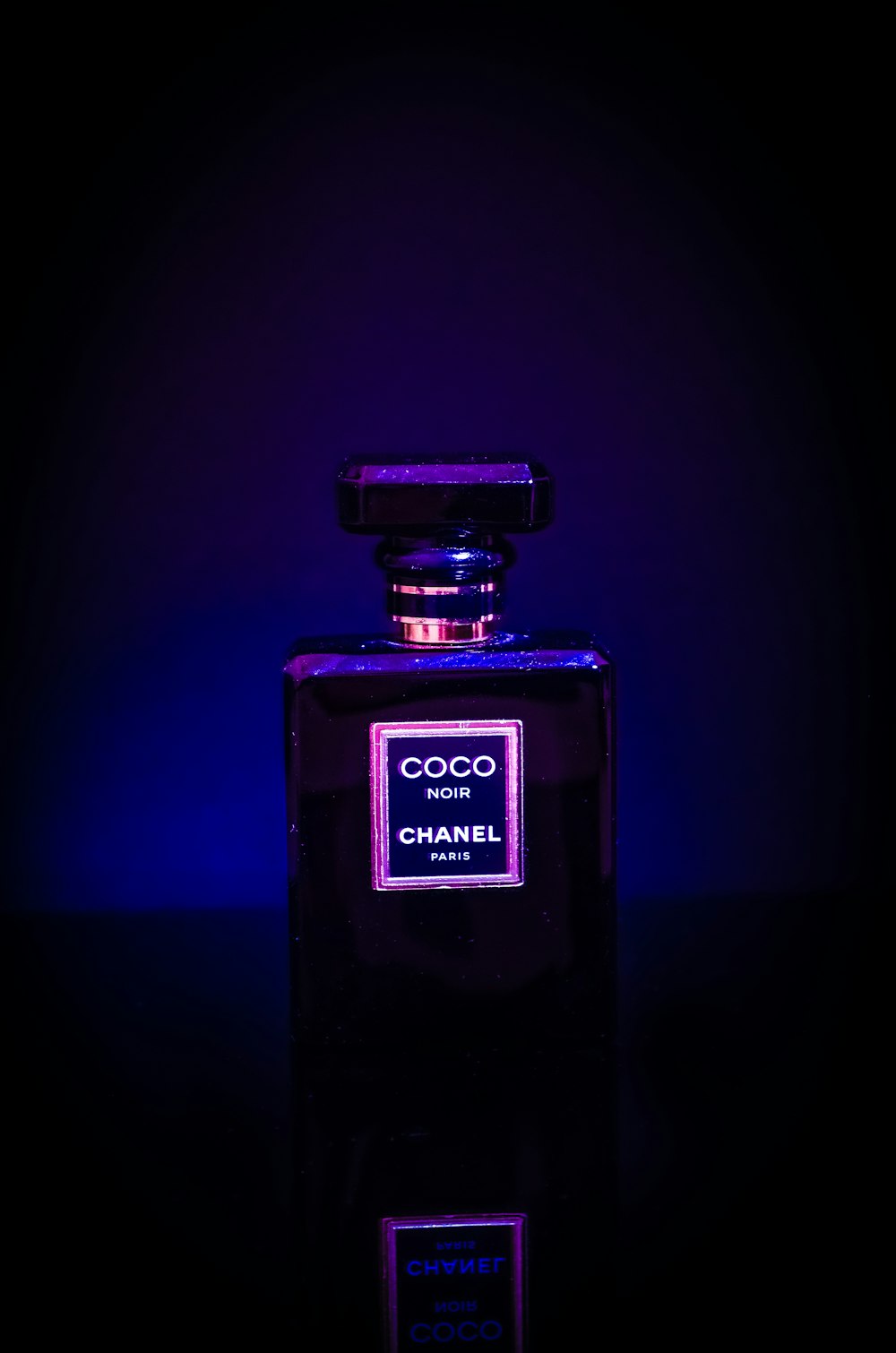 a bottle of chanel perfume lit up in the dark