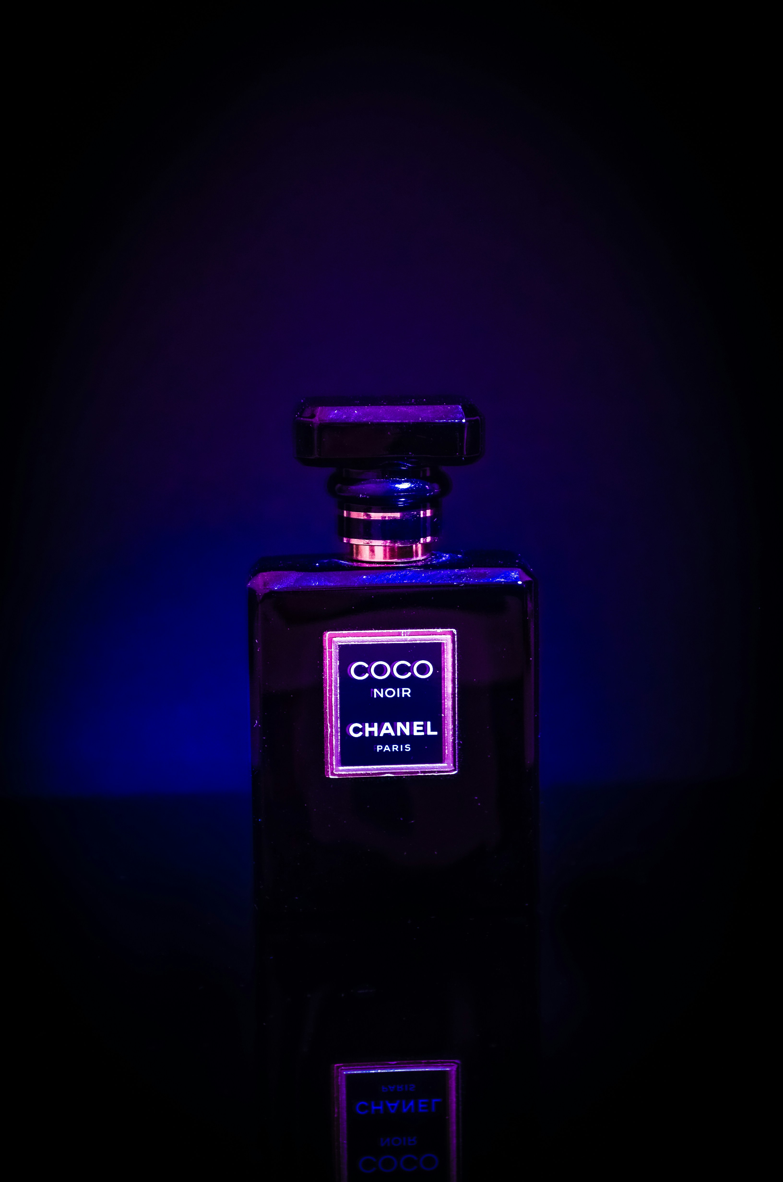 a bottle of chanel perfume lit up in the dark