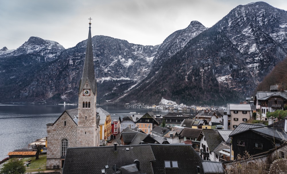 a village with a church and mountains in the background