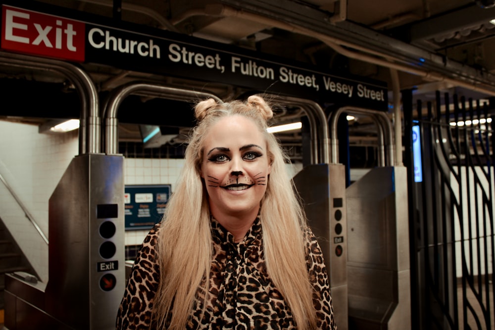 a woman in a leopard print shirt with a fake nose