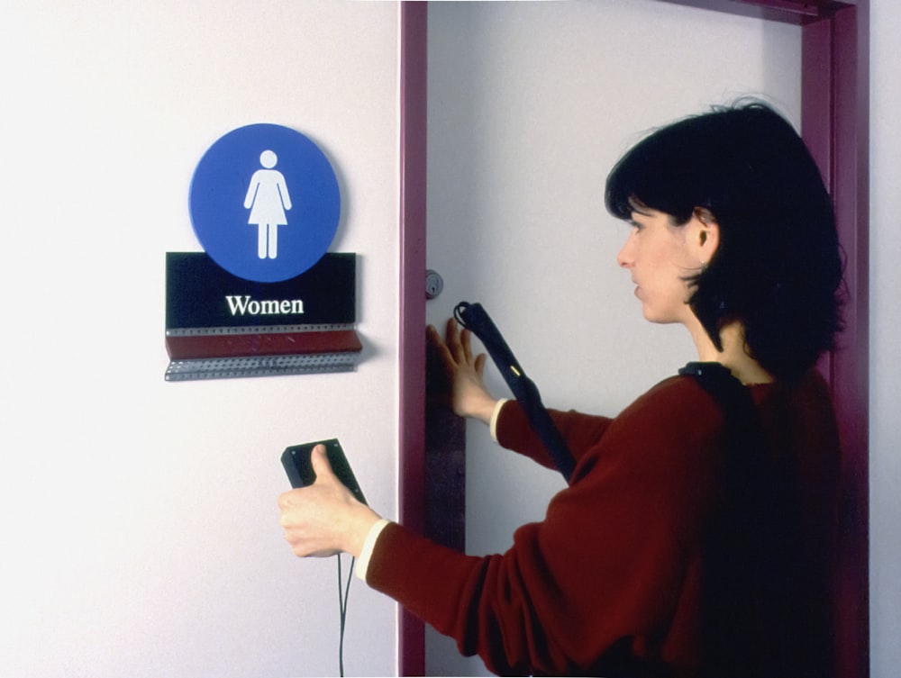 a woman using a hair dryer to dry her hair