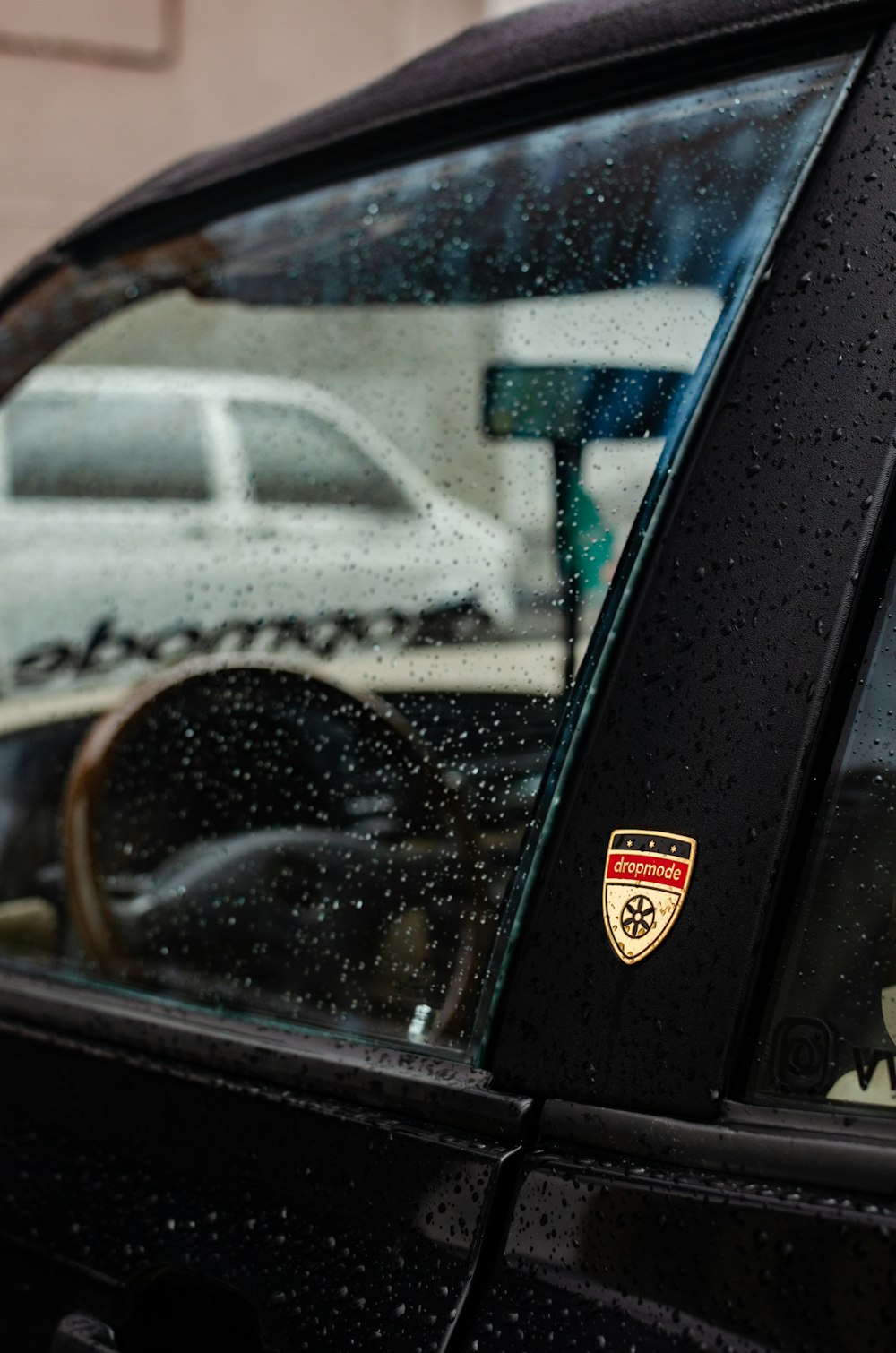 a close up of a car's window with rain drops