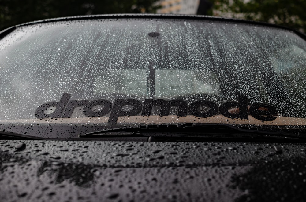 a close up of a car with rain drops on it