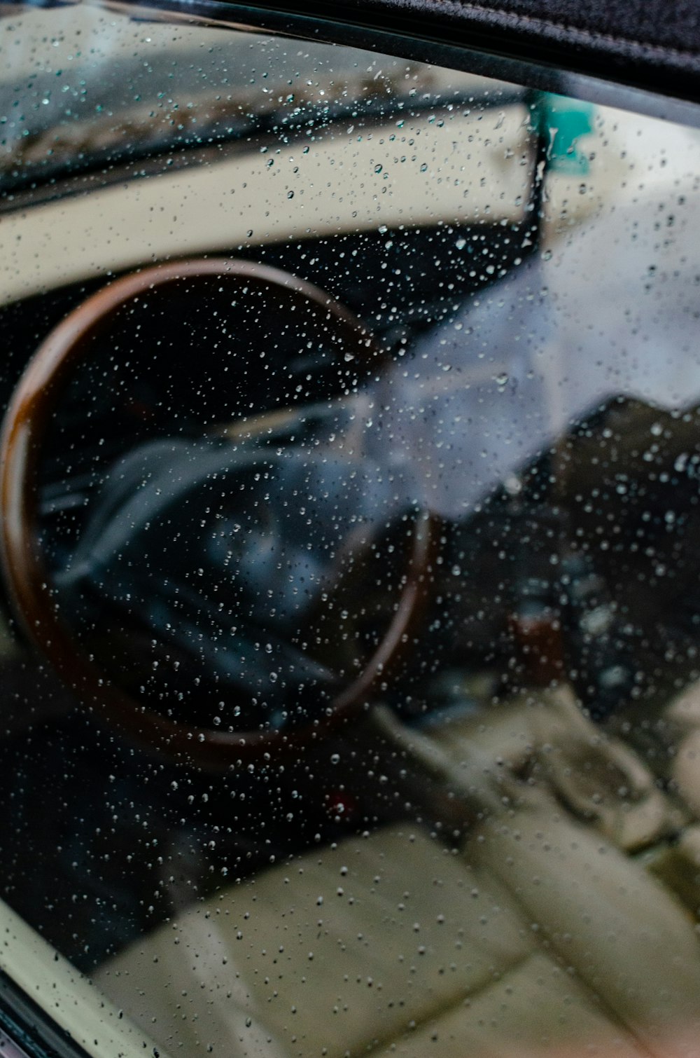 a person sitting in a car in the rain