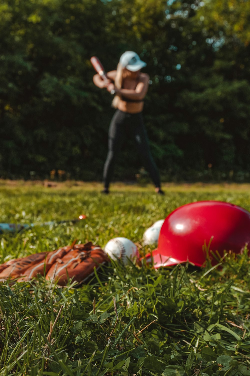 a woman is playing baseball in a field