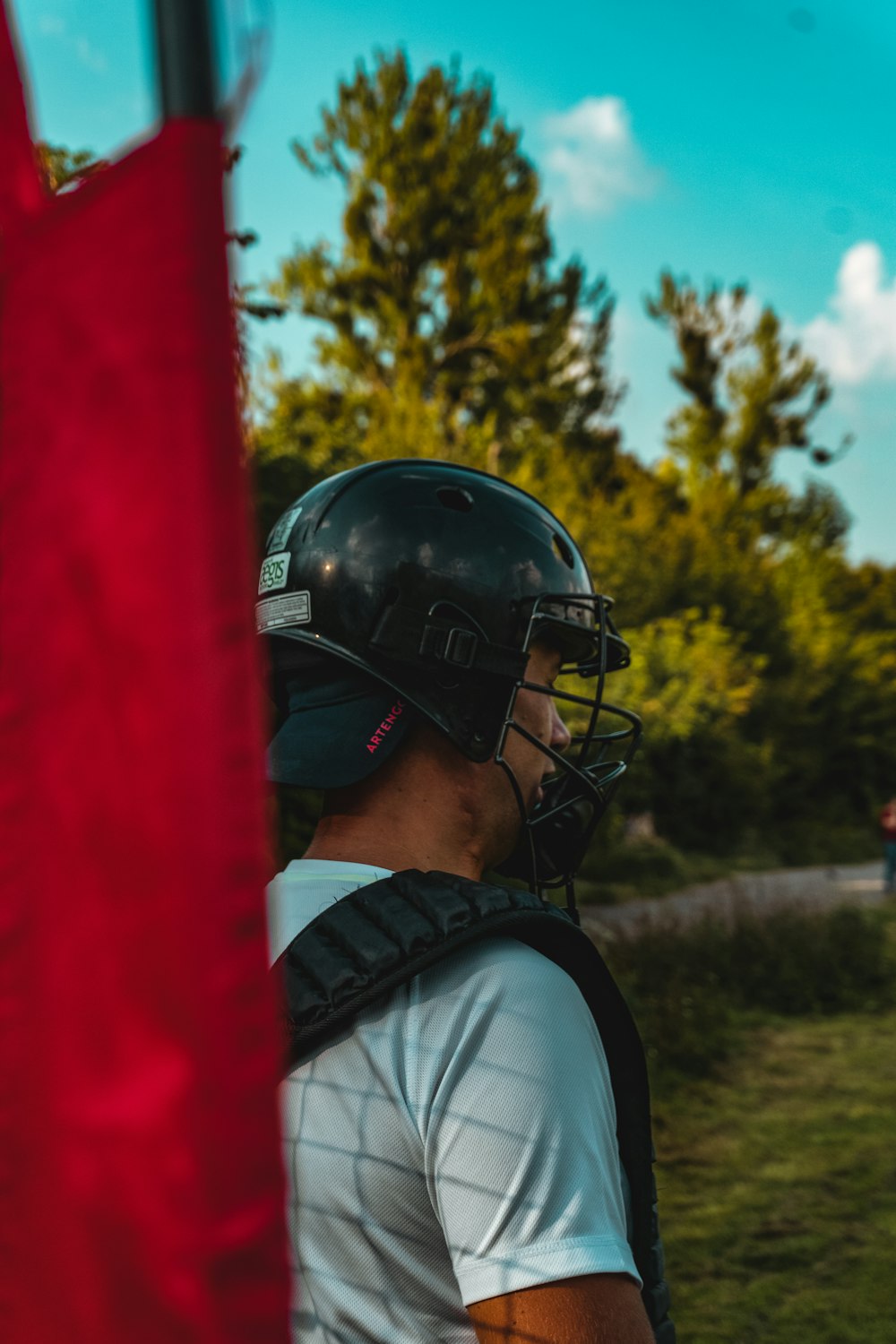 a man wearing a helmet and carrying a baseball bat