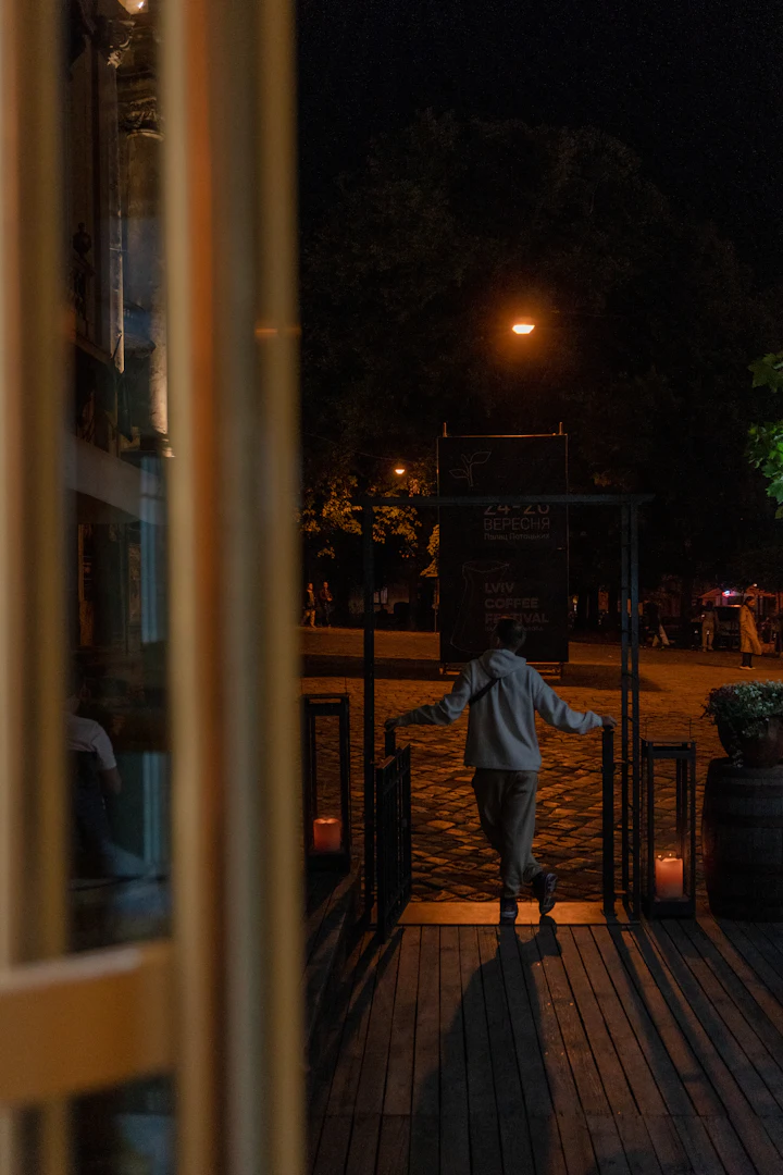 Person standing on a porch at night