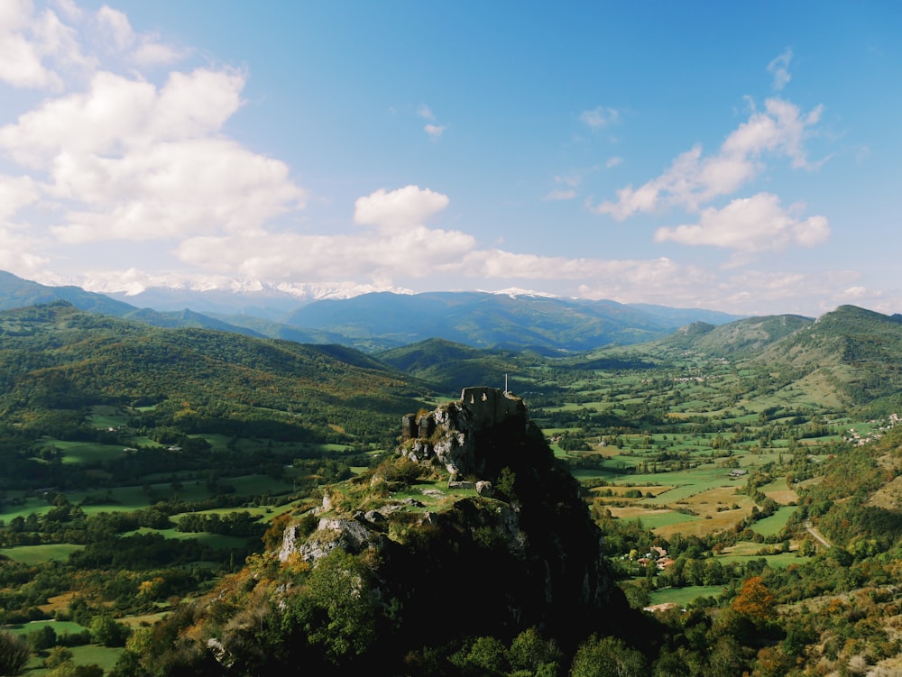 a scenic view of a valley with mountains in the background