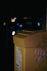 a close up of a yellow box with graffiti on it