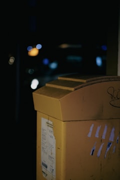 a close up of a yellow box with graffiti on it