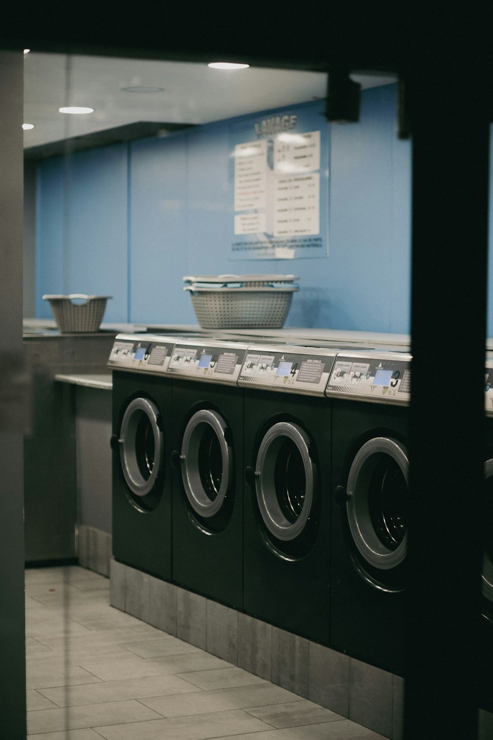 a row of washing machines in a public laundment