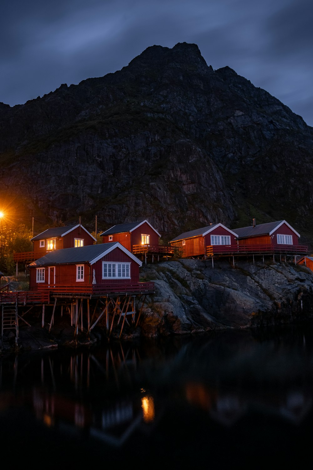 a row of red houses sitting on top of a mountain