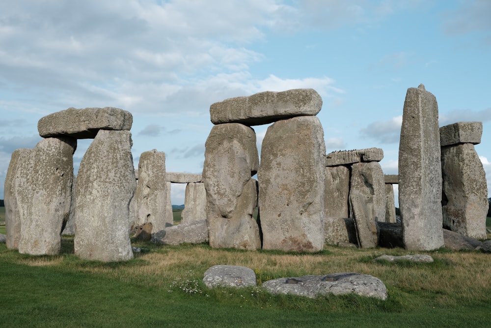 a large stonehenge in a grassy field