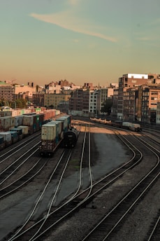 A rail yard at sunset showing multiple railcars ready for service.