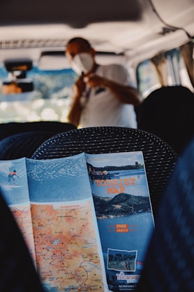 a person sitting in a vehicle with a map