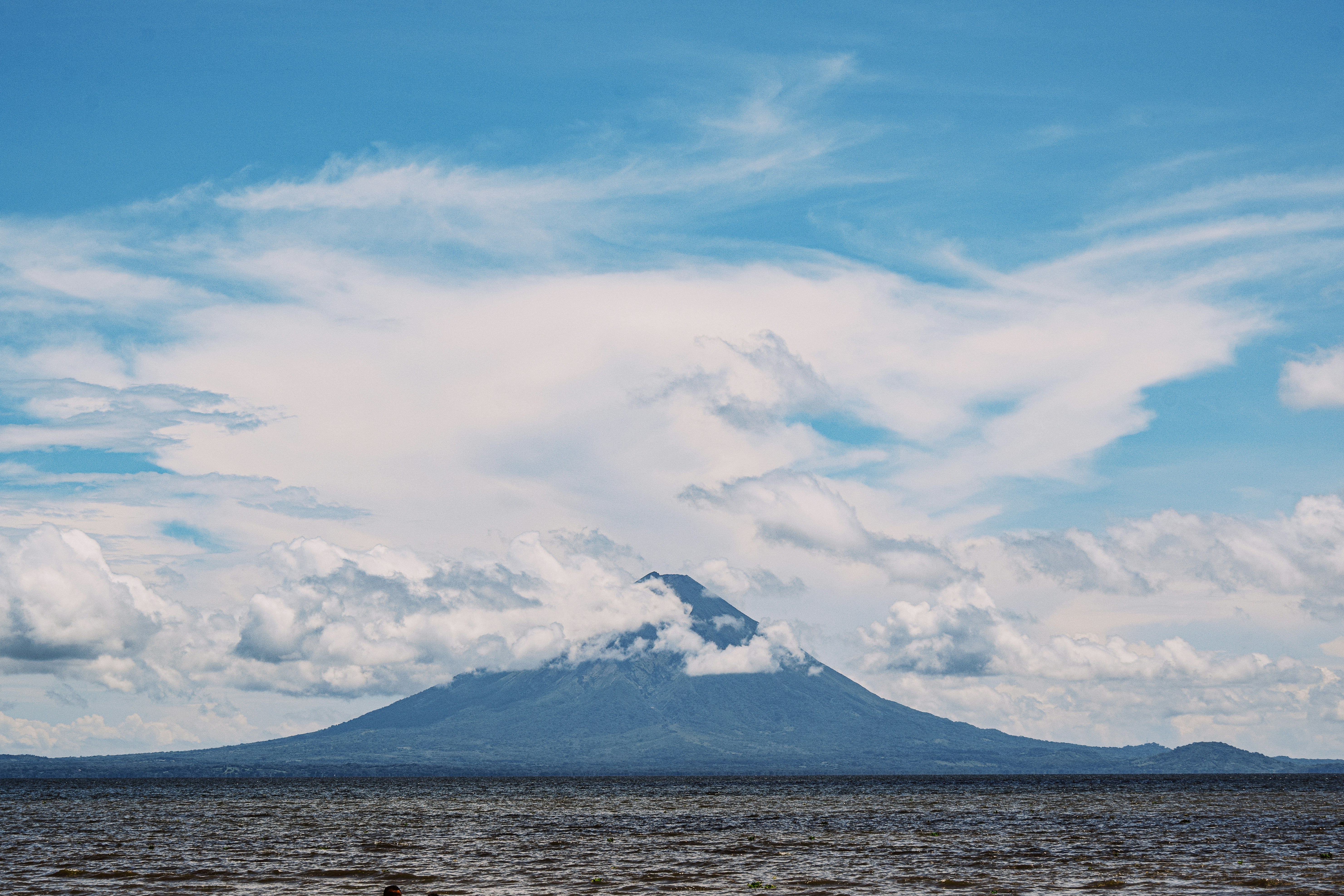 a view of a mountain with clouds in the sky