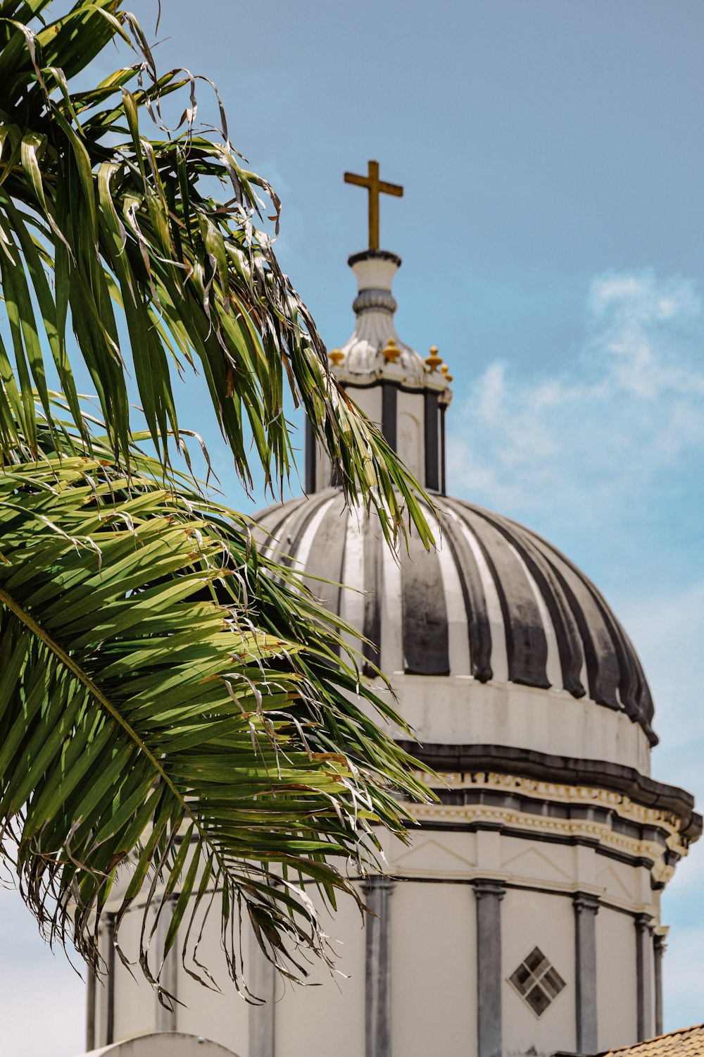 a large white dome with a cross on top