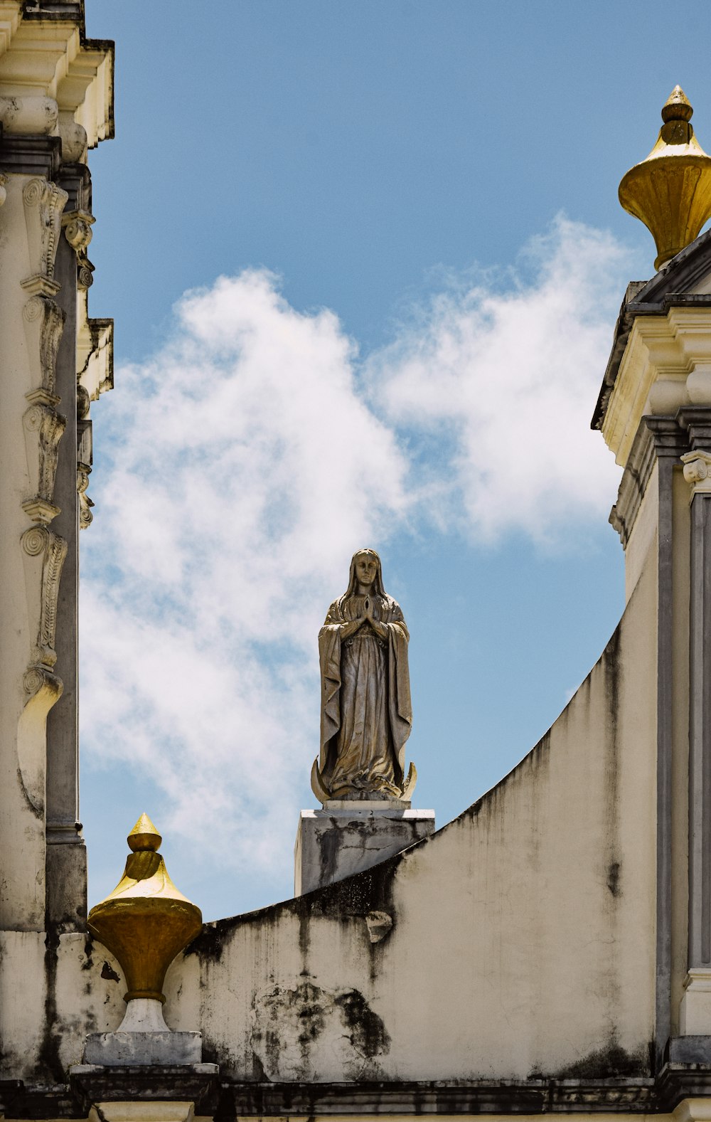 a statue of a person on top of a building