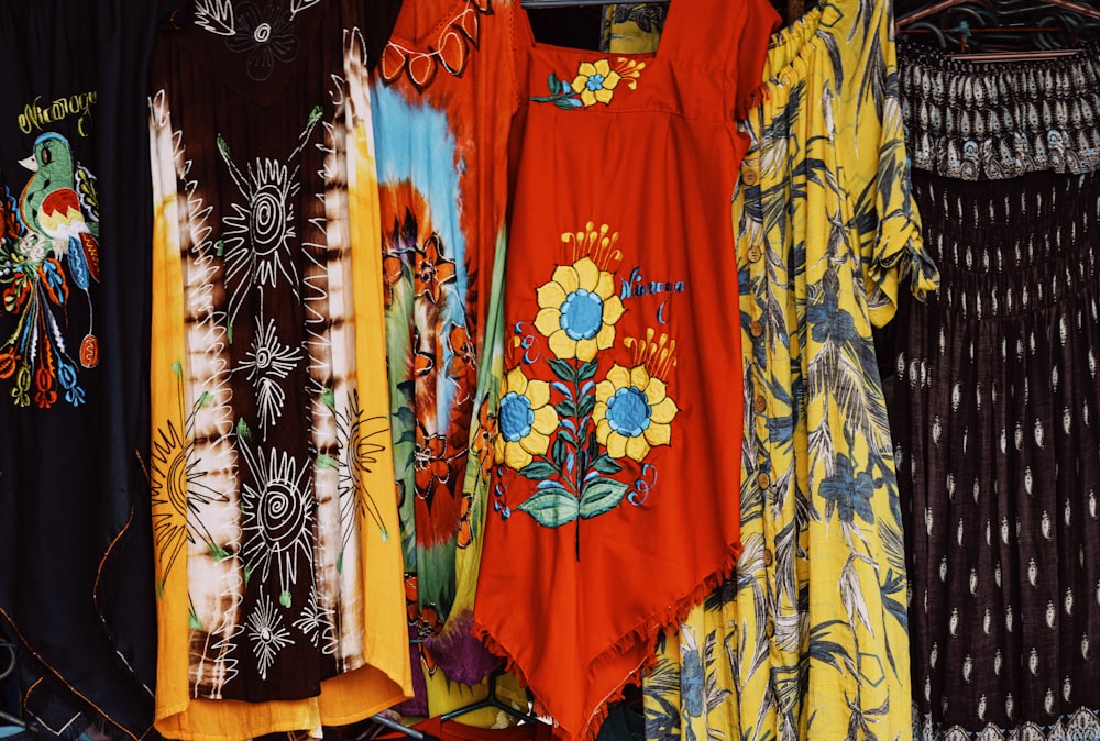 a bunch of dresses hanging on a rack