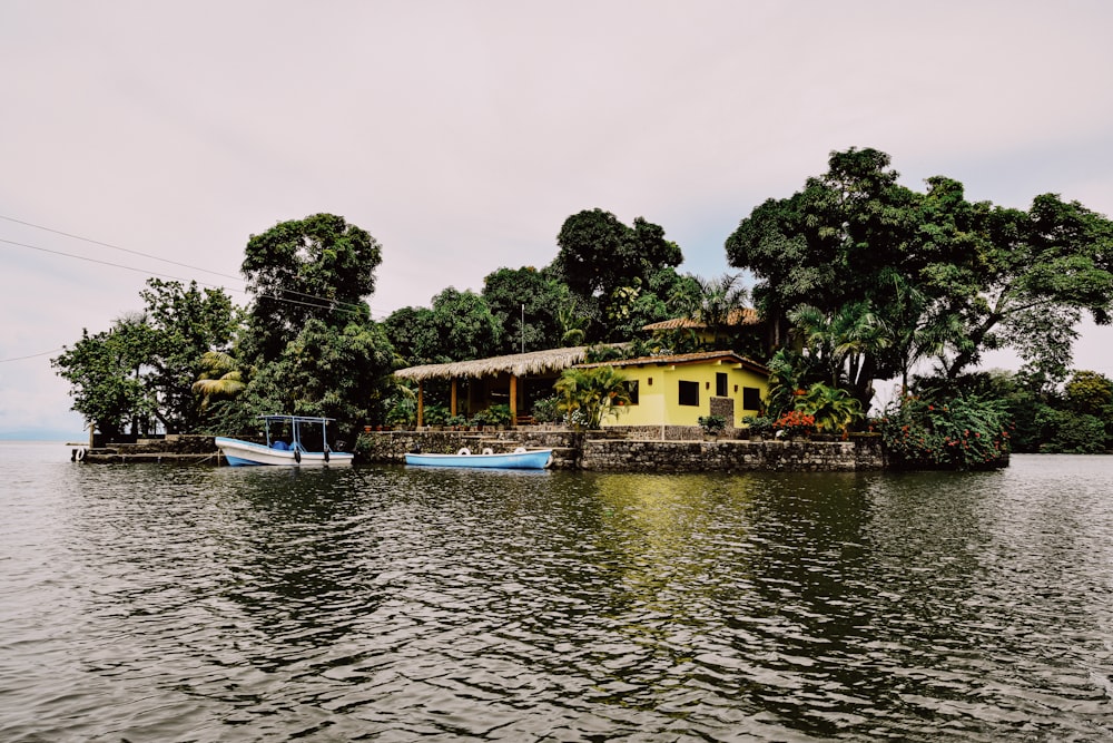 a house on a small island in the middle of a lake