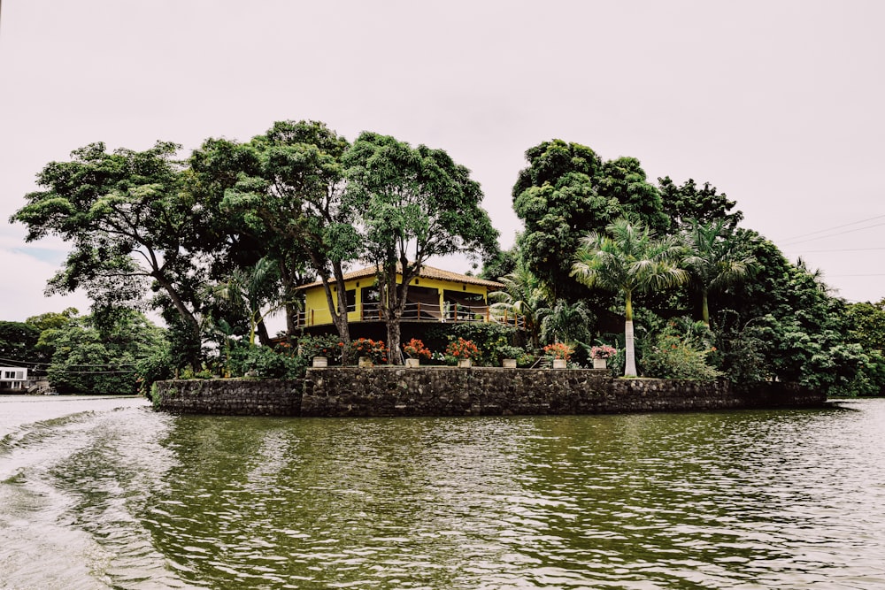 a house on a small island in the middle of a lake