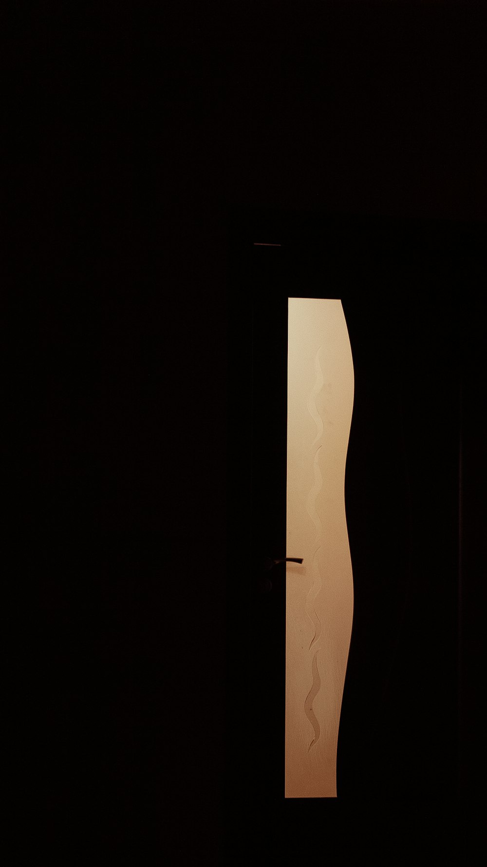 a silhouette of a person standing in a doorway