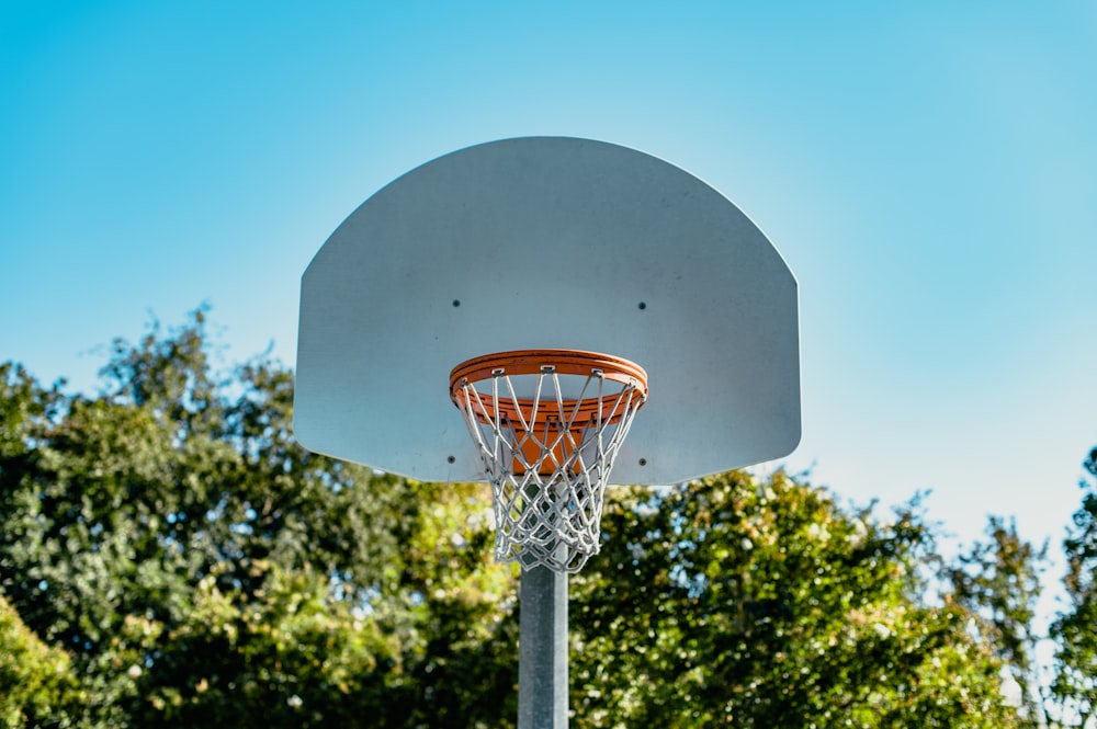 a basketball hoop in front of some trees