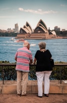 a couple of people that are looking at the water