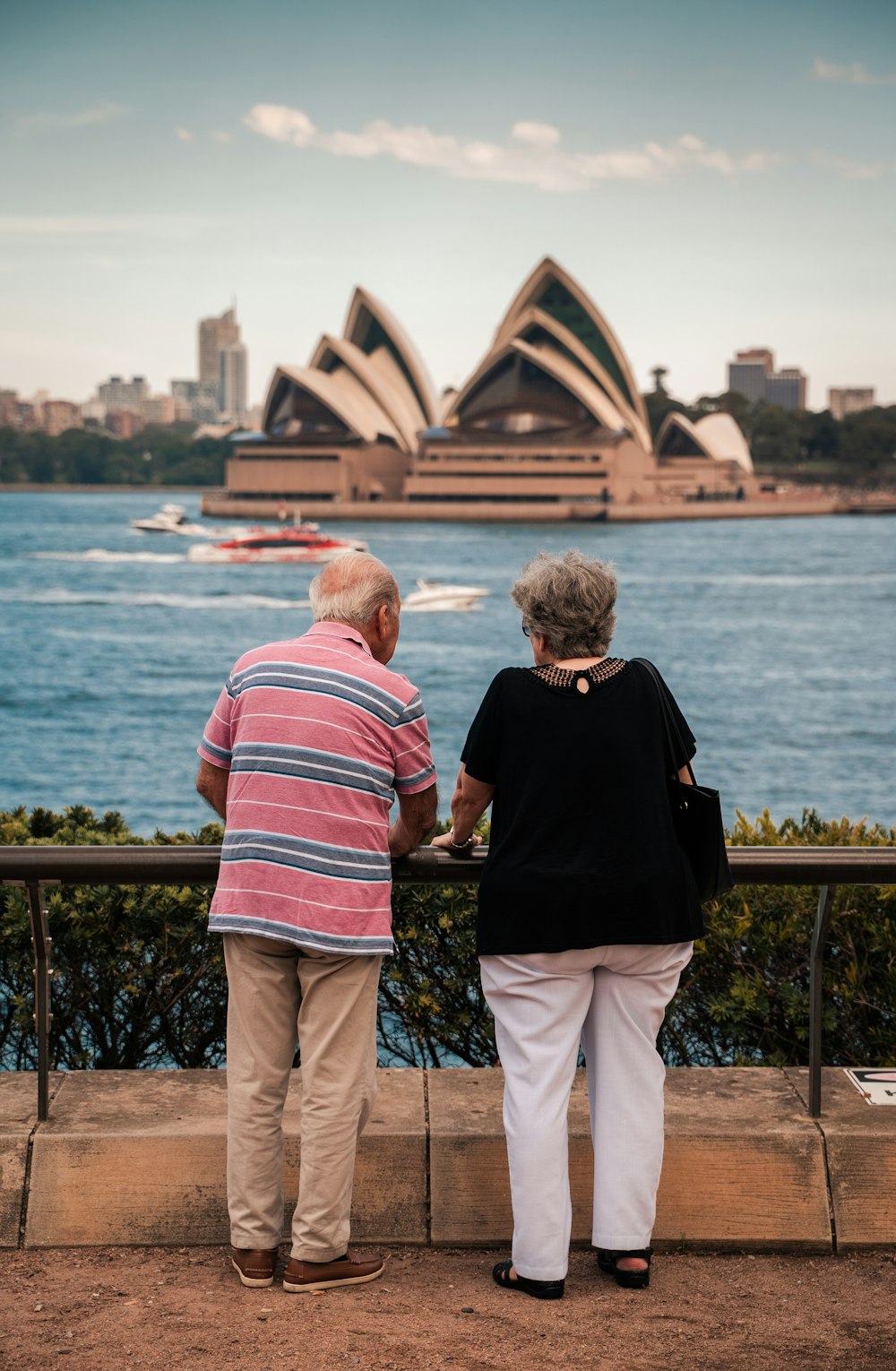 a couple of people that are looking at the water