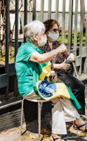 a woman sitting on a chair with a face mask on
