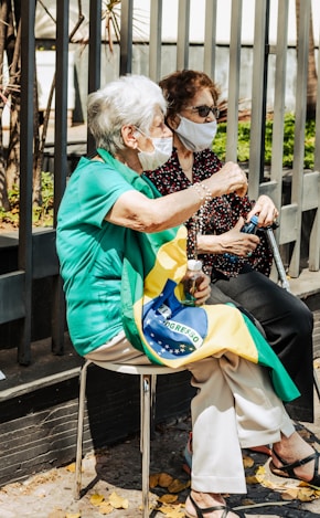 a woman sitting on a chair with a face mask on