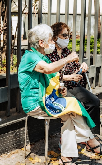 a woman sitting on a chair with a face mask on