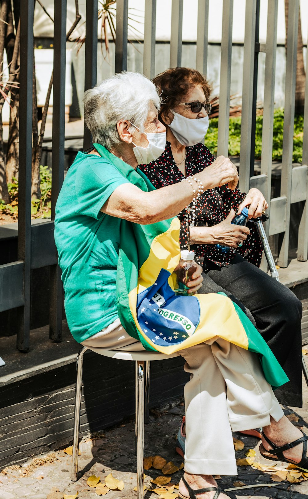 a woman sitting on a chair with a face mask on