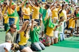 a large group of people in yellow and green shirts