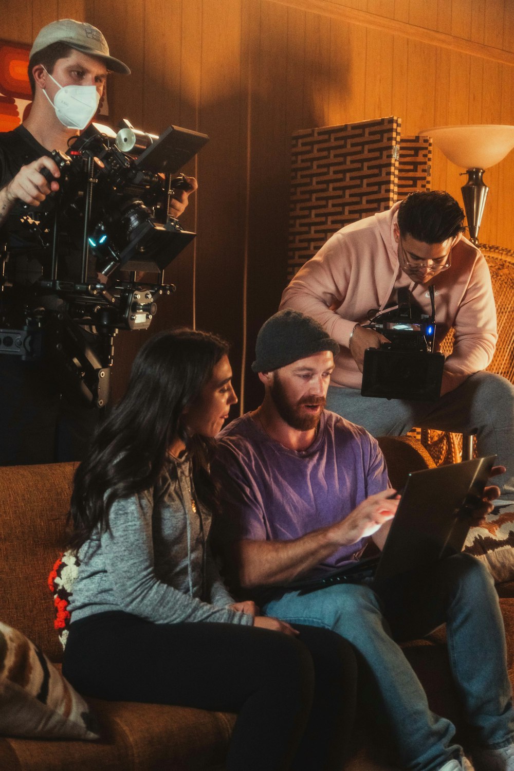 a group of people sitting on a couch in front of a camera