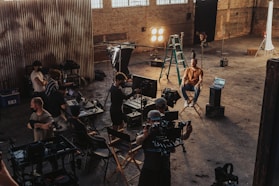 a group of people standing around a camera set up