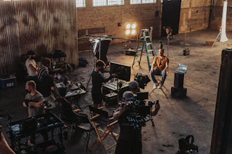 a group of people standing around a camera set up
