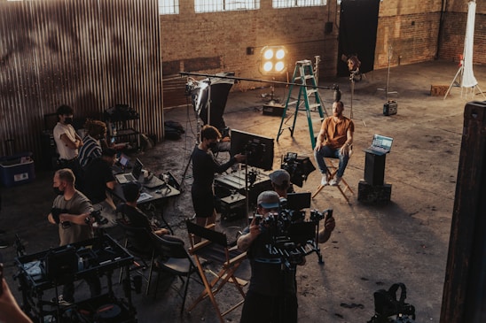 A diverse group of filmmakers discussing ideas in a bright studio space.