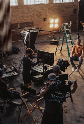 a group of people standing around a camera set up