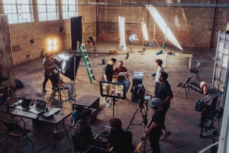 a group of people standing around a camera set up