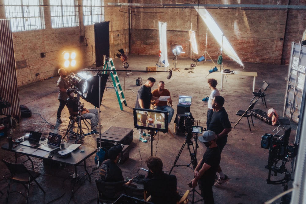 a group of people standing around a camera set up