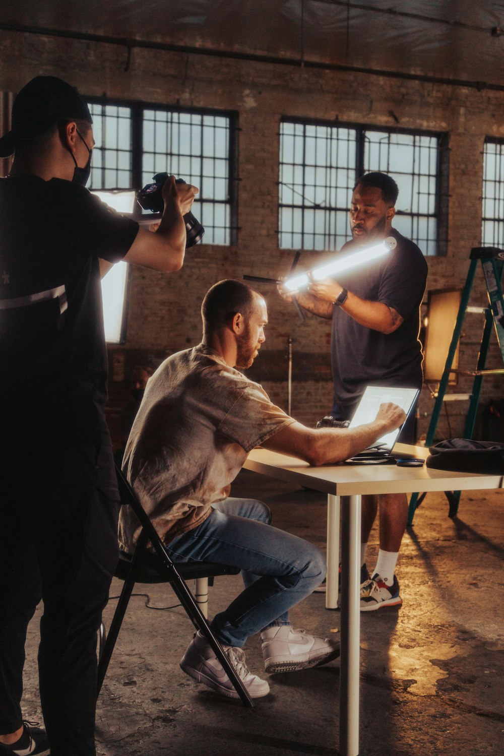 a man sitting at a table in front of a camera