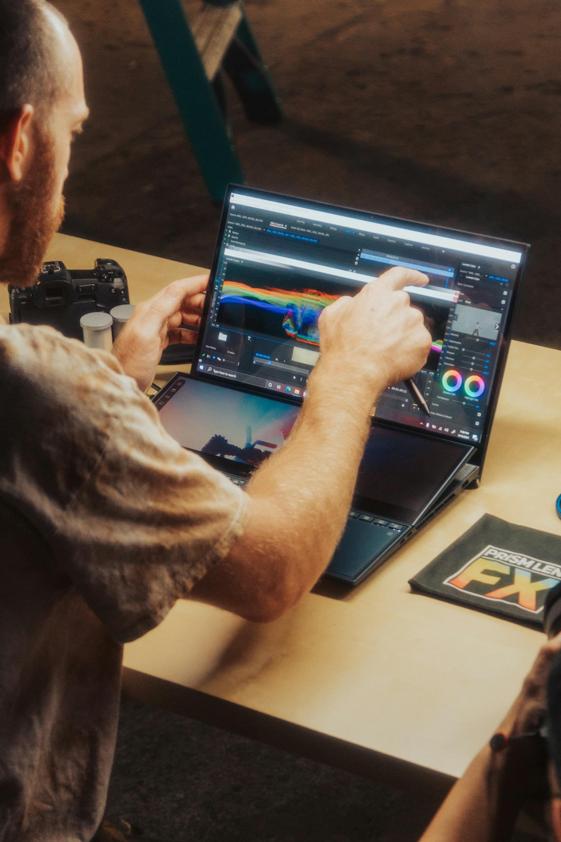 a man sitting at a table using a laptop computer