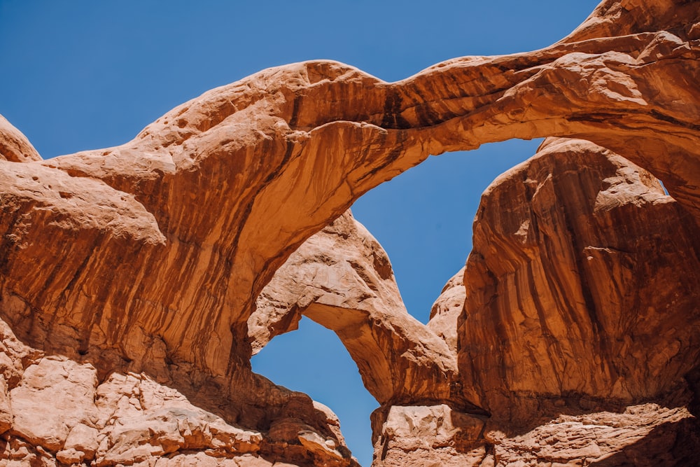 a large rock formation with a blue sky in the background