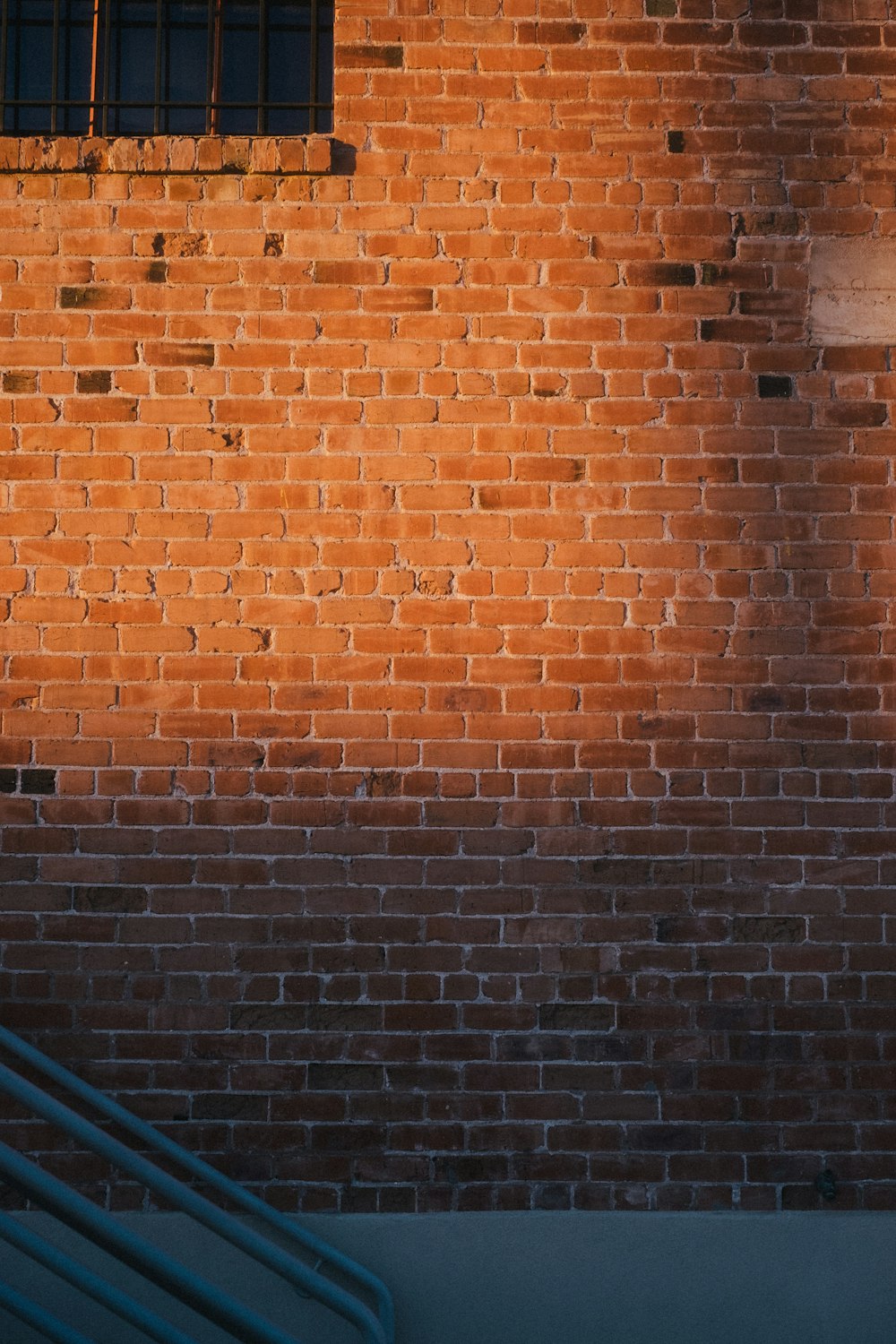 a red brick wall with a clock on it